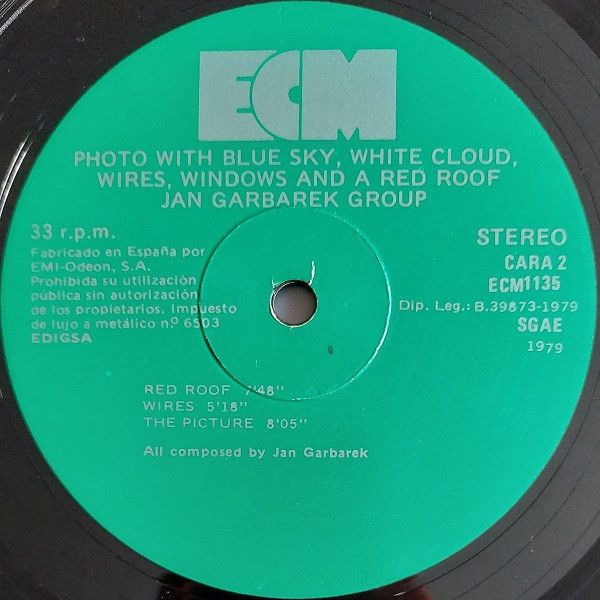 Photo With Blue Sky, White Cloud, Wires, Windows And A Red Roof